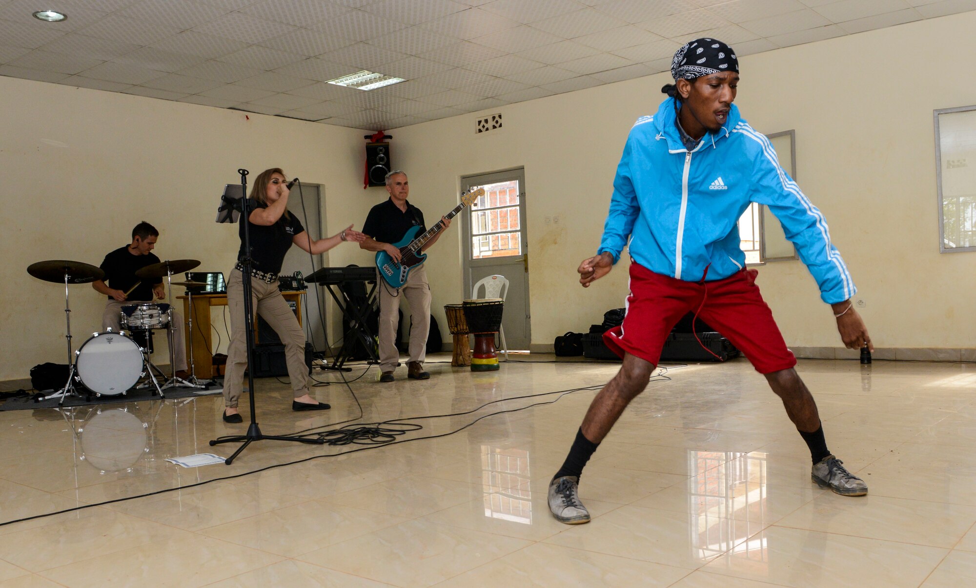 A student dances to music played by the U.S. Air Forces in Europe Band Touch N' Go during a performance at the Gisimba Memorial Centre in Kigali, Rwanda, March 6, 2019. As musical ambassadors, members of the band can reach audiences that traditional military members can't. They travel the world to build cultural bridges, and honor and preserve cultural heritage. (U.S. Air Force photo by Tech. Sgt. Timothy Moore)