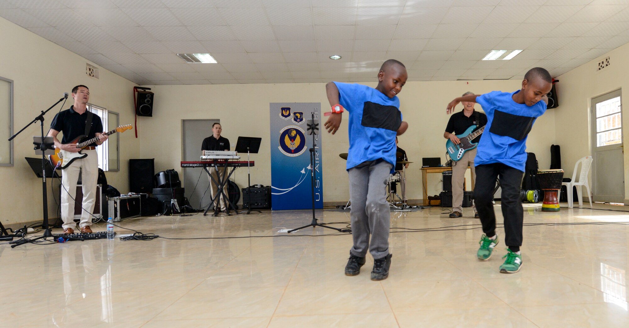 Students dance to music played by the U.S. Air Forces in Europe Band Touch N' Go during a performance at the Gisimba Memorial Centre in Kigali, Rwanda, March 6, 2019. As musical ambassadors, members of the band can reach audiences that traditional military members can't. They travel the world to build cultural bridges, and honor and preserve cultural heritage. (U.S. Air Force photo by Tech. Sgt. Timothy Moore)