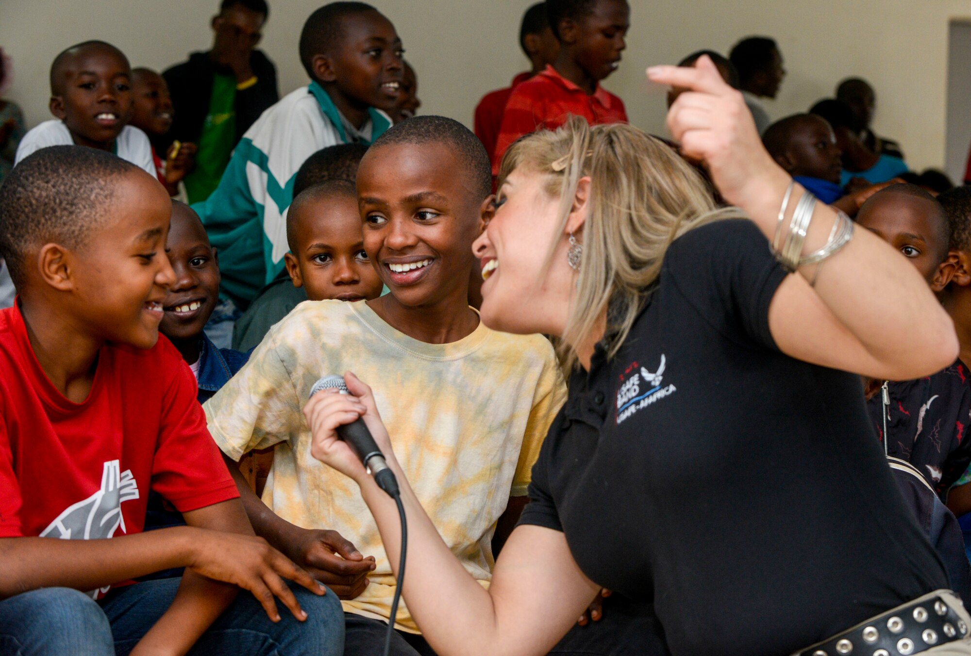 Students sing along with U.S. Air Force Senior Airman Linda Casul, U.S. Air Forces in Europe Band vocalist, during a performance at the Gisimba Memorial Centre in Kigali, Rwanda, March 6, 2019. As musical ambassadors, members of the band can reach audiences that traditional military members can't. They travel the world to build cultural bridges, and honor and preserve cultural heritage. (U.S. Air Force photo by Tech. Sgt. Timothy Moore)