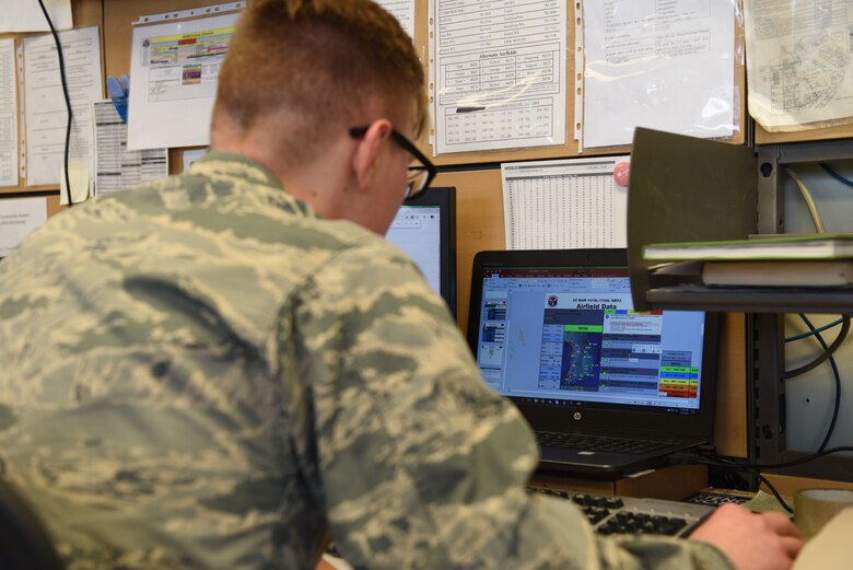 U.S. Air Force 1st Lt. Jonathan Napora, 8th Operations Support Squadron wing weather officer, builds a slideshow depicting airfield data for various bases on the Korean peninsula at Kunsan Air Base, Republic of Korea, March 5, 2019. Napora and his shop ensure pilots are briefed with the latest weather updates before takeoff. (U.S. Air Force photo by Staff Sgt. Joshua Edwards)