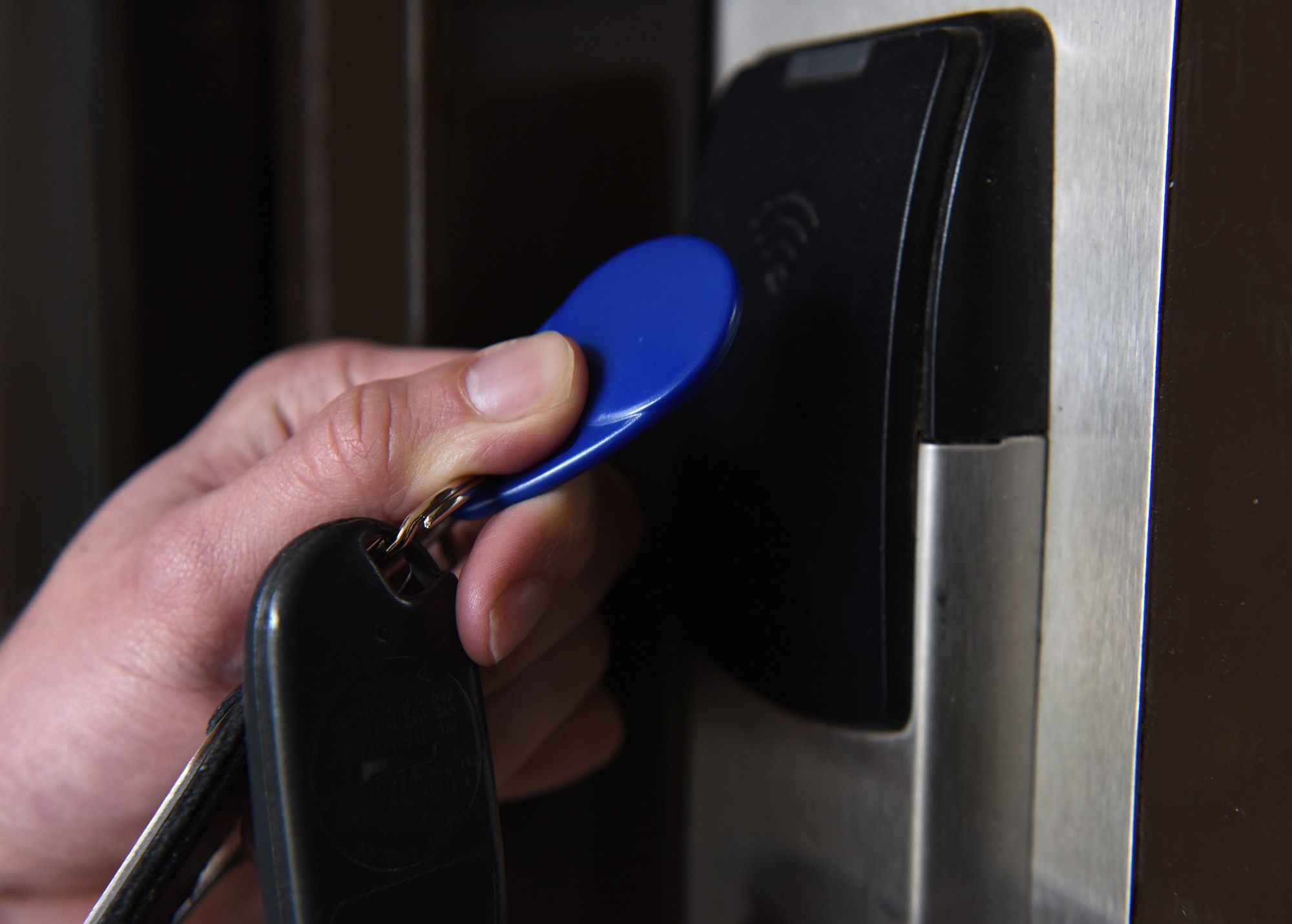 An Airman uses a key fob to access his dorm room at Royal Air Force Lakenheath, England, March 7, 2019. The key fob allows connection to a keyring and supplements the regular keycards assigned to the Airmen.