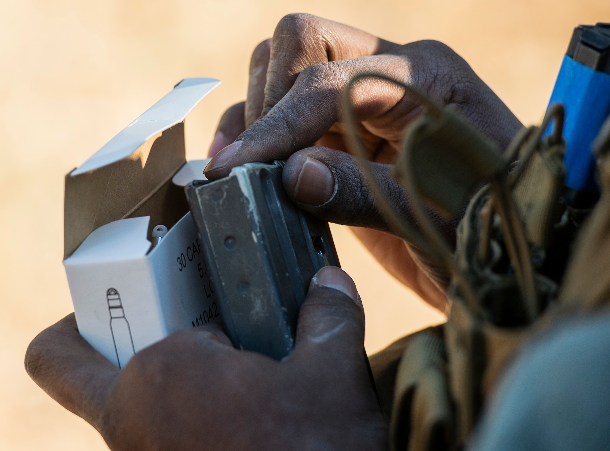A U.S. Airman assigned to the 20th Security Forces Squadron loads a magazine with dummy-rounds prior to a force-on-force training at Poinsett Electronic Combat Range near Wedgefield, S.C., March 6, 2019.