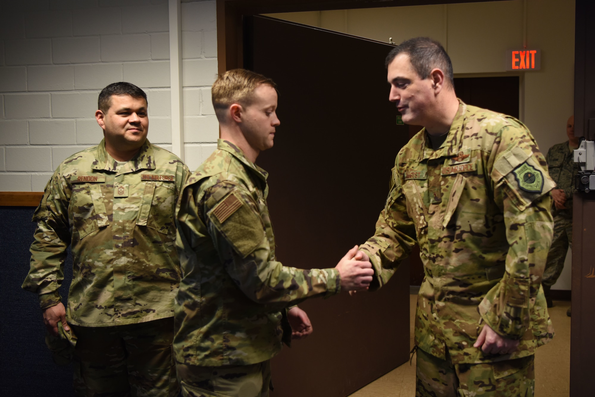 Tech Sgt. Gabriel Vest, 86th Airlift Wing Maintenance Group, training management noncommissioned officer in charge shakes hands with Brig. Gen. Mark August, 86th AW commander accompanied by Chief Master Sgt. Ernesto Rendon, 86th AW command chief. Vest was named Airlifter of the Week, a program which recognizes Ramstein Airmen who are devoted to making the 86th AW the “World’s Best Wing.”