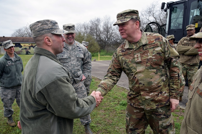 Lt. Gen. Richard Scobee, commander of the Air Force Reserve Command, presents a coin to Senior Airman Sajjad Al Khafaji, 26th Aerial Port Squadron ramp specialist, March 2, 2019 at Joint Base San Antonio-Lackland, Texas.