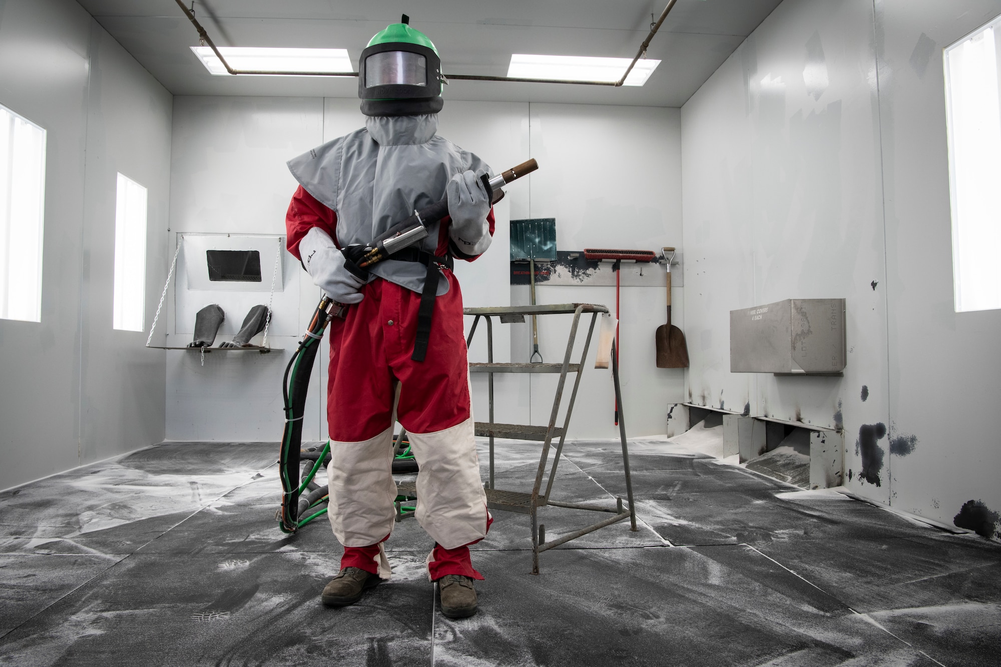 U.S. Air Force Airman 1st Class Evan Green, 33rd Maintenance Squadron Low Observable aircraft structural maintenance journeyman, holds the blast hose Feb. 21, 2019, at Eglin Air Force Base, Fla. The Corrosion Control compound is working on getting their brand new media booth certified to allow them to work on larger scale projects while saving man hours. (U.S. Air Force photo by Airman 1st Class Daniella Peña-Pavao)