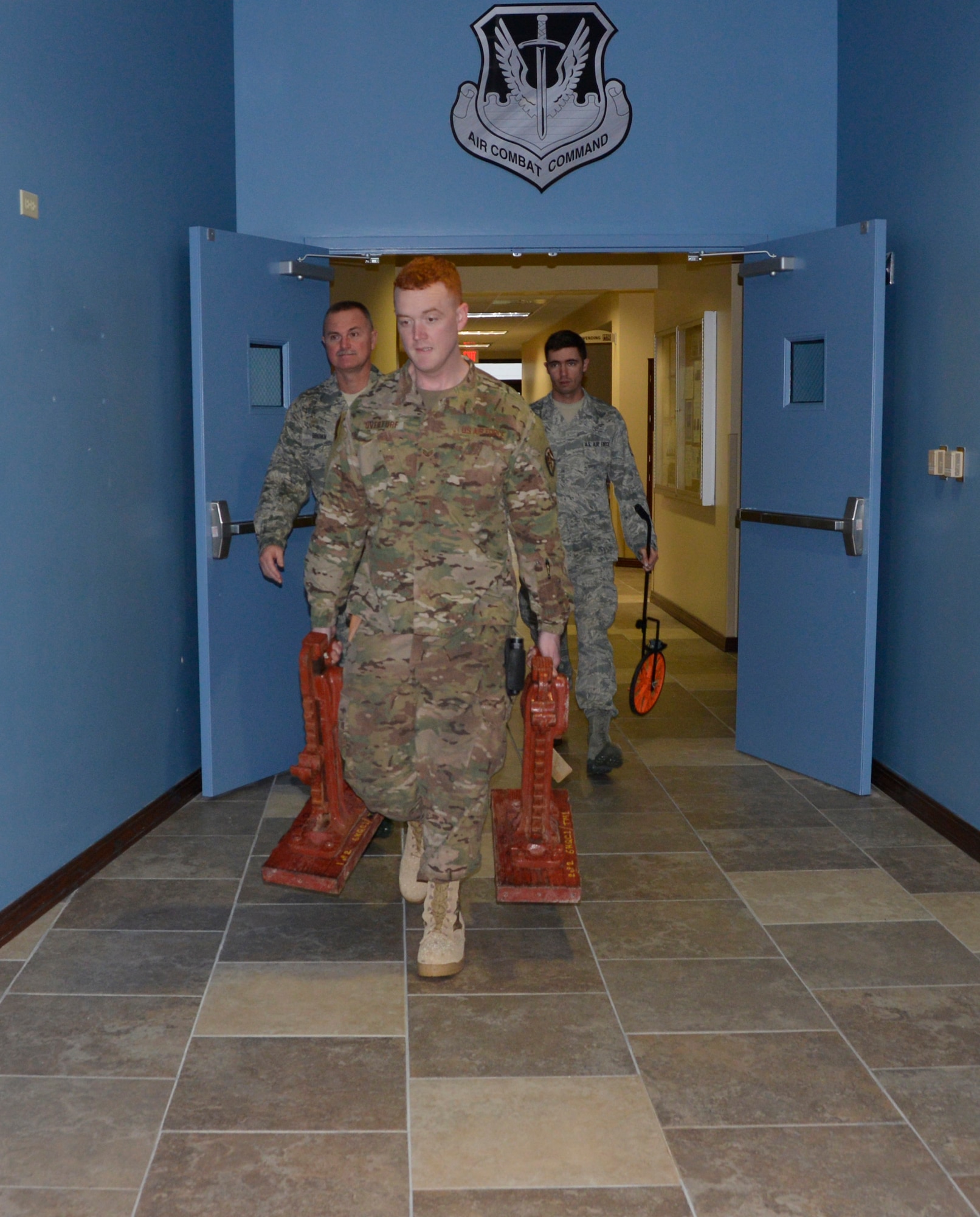(L-R) Master Sgt. Keith Brown, Staff Sgt. Jeremy Overturf, and Staff Sgt. Anthony Martin, all from the 241st Engineering Installation Squadron, Chattanooga, Tenn., carry communications cable equipment into the 1st Air Force (Air Forces Northern) Headquarters building. They are part of a group of seven Airmen from the 241st EIS who deployed here to assist the 1st AF (AFNORTH) enterprise to restore its communications and computer capabilities following the devastating effects of Hurricane Michael Oct. 10, 2018. (Air Force photo by Mary McHale)