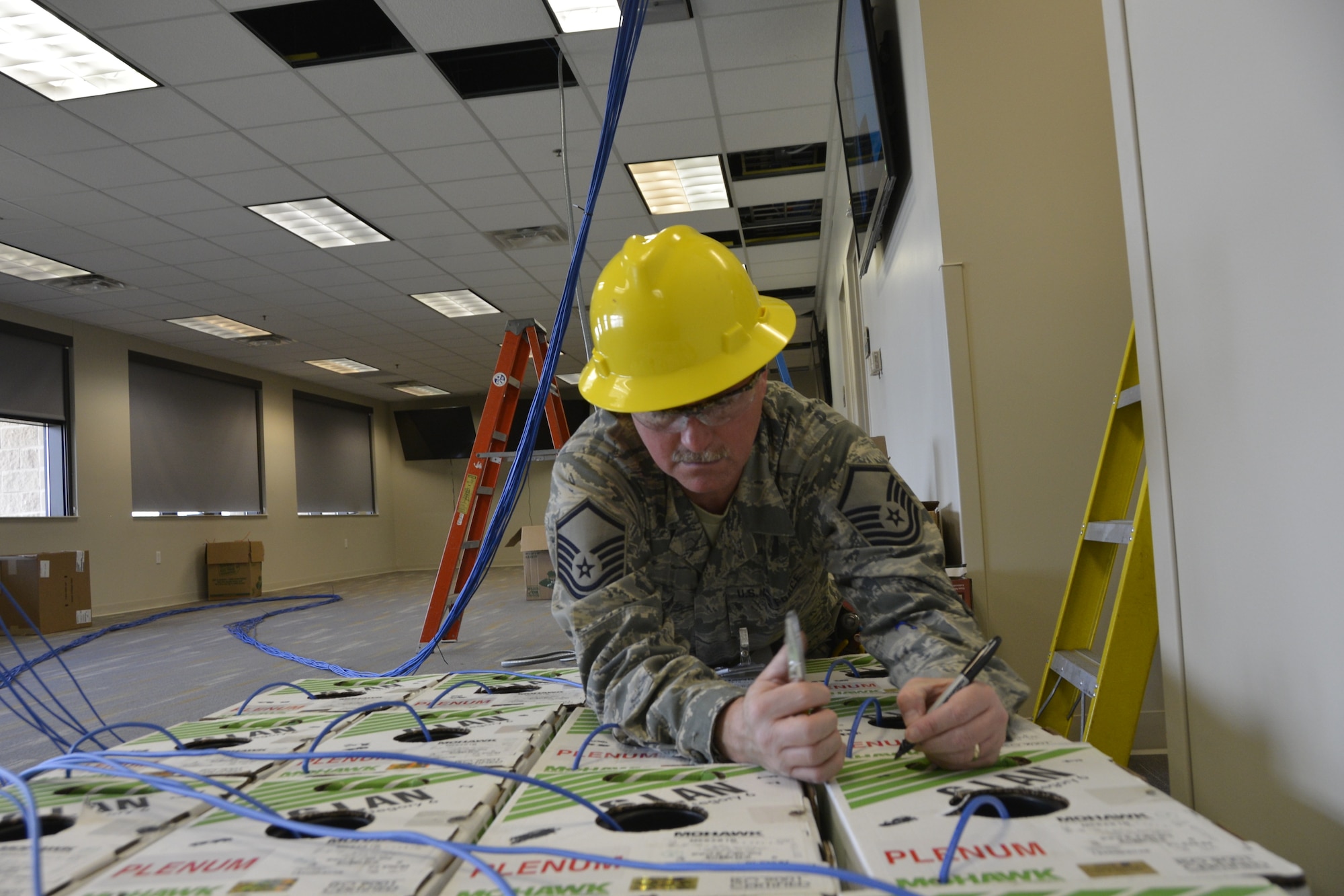 Master Sgt. Keith Brown, cyber transport specialist with the 241st Engineering Installation Squadron, Chattanooga, Tenn., marks the order of boxes of copper cable prior to installation. Brown is part of a group of seven Airmen from the 241st EIS who deployed here to assist the 1st AF (AFNORTH) enterprise to restore its communications and computer capabilities following the devastating effects of Hurricane Michael Oct. 10, 2018. (Air Force photo by Mary McHale)