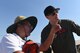 An airshow visitor asks Staff Sgt. Chandler, MQ-9 Reaper sensor operator, a question about the Reaper's targeting system during the Australian International Airshow, Mar. 2, 2019, in Geelong, Victoria, Australia. Reaper crews have made their way across the United States to attend airshows such as this one, but this is their first time in the Pacific Air Forces Command area of responsibility and Australia. (U.S. Air Force photo by Airman 1st Class Haley Stevens)