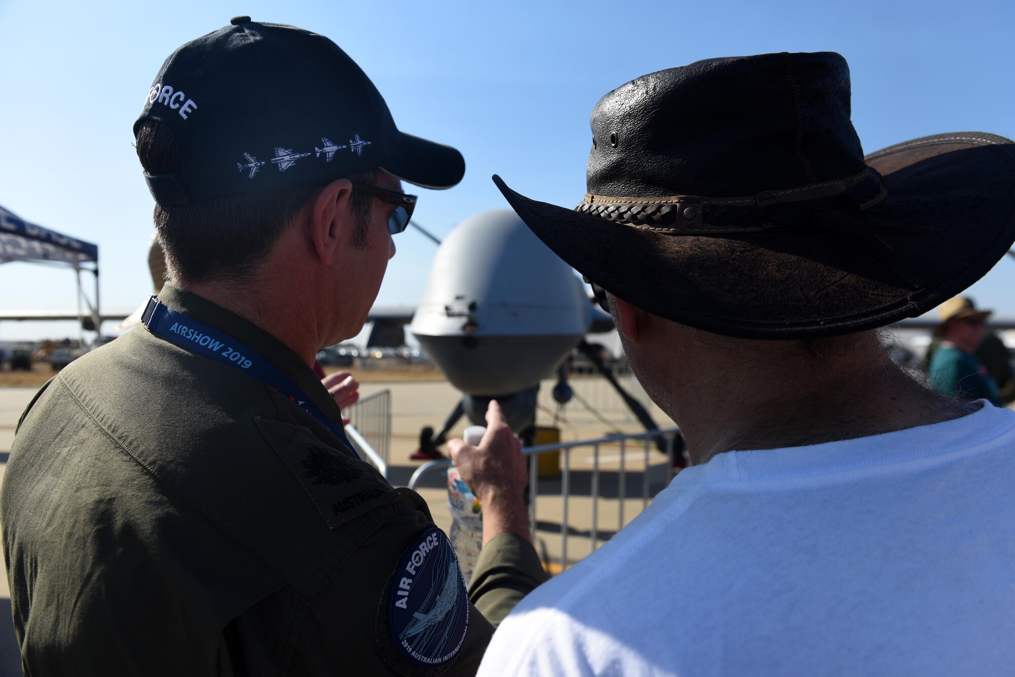 A member of the Royal Australian Air Force answers a question during the Australian International Airshow, Mar. 2, 2019, in Geelong, Victoria, Australia. The MQ-9 proved to be a popular attraction due to its unique capabilities and the team’s mission of persistent attack and reconnaissance. (U.S. Air Force photo by Airman 1st Class Haley Stevens)