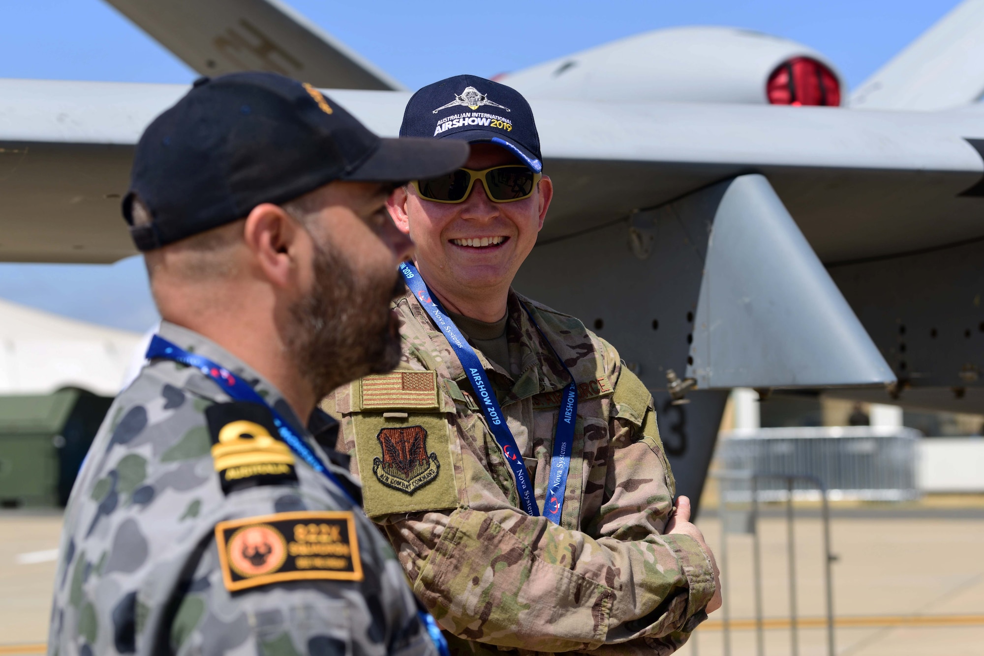 Master Sgt. Daren speaks with a member of the Australian Defence Force about the MQ-9 Reaper during the Australian International Airshow, Feb. 26, 2019, in Geelong, Victoria, Australia. In line with the focus of strengthening the relationship between the Australian Defence Force and United States Military, the U.S. Air Force and Creech Airmen brought the Remotely Piloted Aircraft to be displayed during this airpower demonstration. (U.S. Air Force photo by Airman 1st Class Haley Stevens)