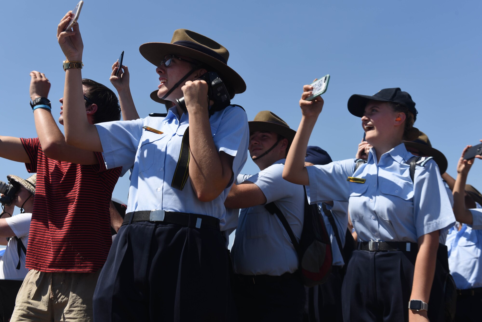 Airshow visitors raise their cameras to the sky to capture airpower in action during the Australian International Airshow, Mar. 2, 2019, in Geelong, Victoria, Australia. Over the week, the Avalon Airfield hosted more that 200,000 visitors and aviation fans. (U.S. Air Force photo by Capt. Annabel Monroe)