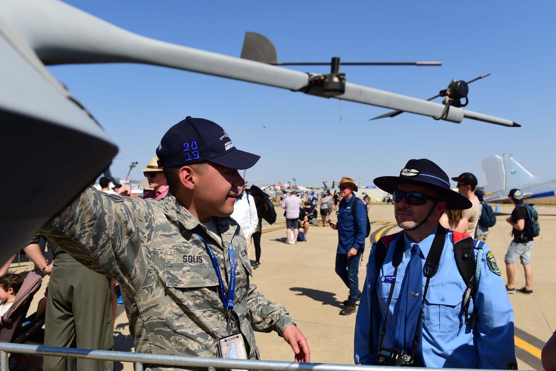 Senior Airman Issac Solis, MQ-9 Reaper crew chief, explains the purpose of different parts of the aircraft during the Australian International Airshow, Mar. 2, 2019, in Geelong, Victoria, Australia. Displaying the aircraft at the Australian International Airshow is not only an opportunity to help RPA Airmen explain their role in national security, but also provides the chance for the U.S. Air Force to show their support for our coalition partners in the Indo-Pacific region. (U.S. Air Force photo by Airman 1st Class Haley Stevens)
