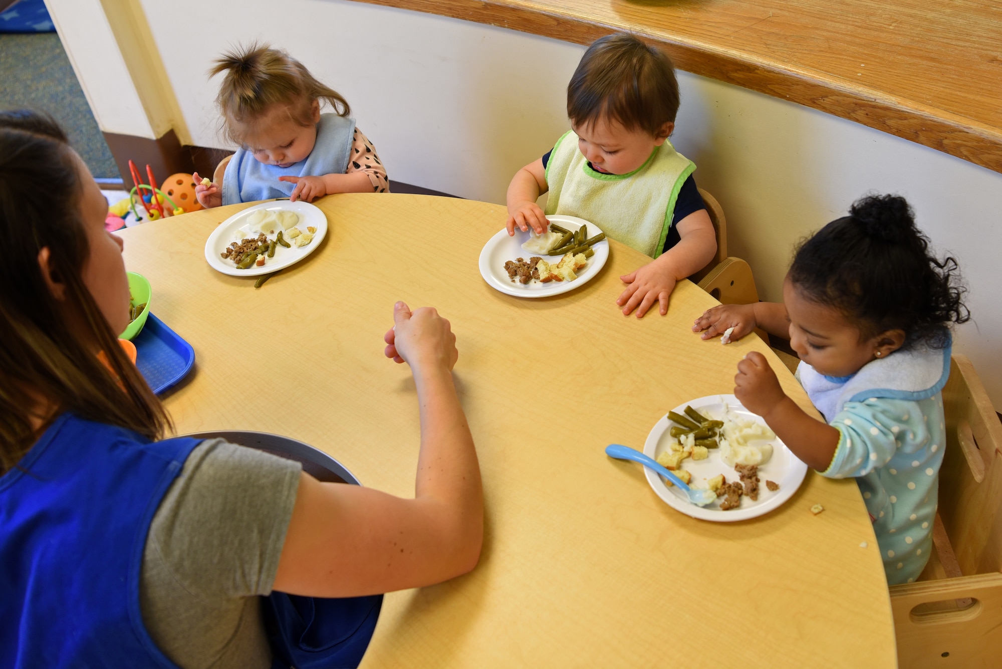 Juliet Yoder, 20th Force Support Squadron Child Development Center caregiver, feeds lunch to the infants in her care at Shaw Air Force Base, S.C., Feb. 25, 2019.