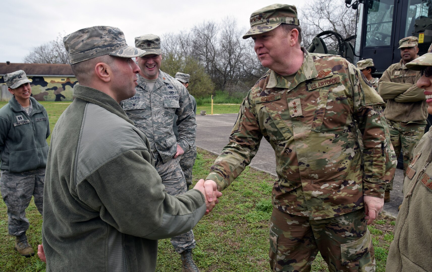 Lt. Gen. Richard Scobee (right), commander of the Air Force Reserve Command, presents a coin to Senior Airman Sajjad Al Khafaji, 26th Aerial Port Squadron ramp specialist at Joint Base San Antonio-Lackland March 2. Khafaji, who previously worked as an interpreter with the U.S. Army in Baghdad, immigrated to the United States five years ago.
