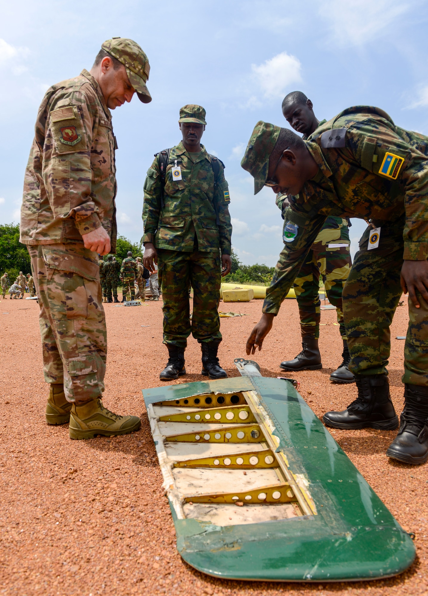 U.S. Air Force Chief Master Sgt. Joe Winfield, U.S. Air Forces in Europe-Air Forces Africa Safety functional manager, discusses details about an aircraft mishap investigation with participants in the African Partnership Flight Rwanda during a field familiarization exercise at the Rwanda Military Academy in Gako, Rwanda, March 7, 2019. Throughout the weeklong African Partnership Flight, participants discussed various aspects of safety, with each country discussing how they conduct their programs, culminating with teams investigating a simulated aircraft crash in the field familiarization exercise. (U.S. Air Force photo by Tech. Sgt. Timothy Moore)