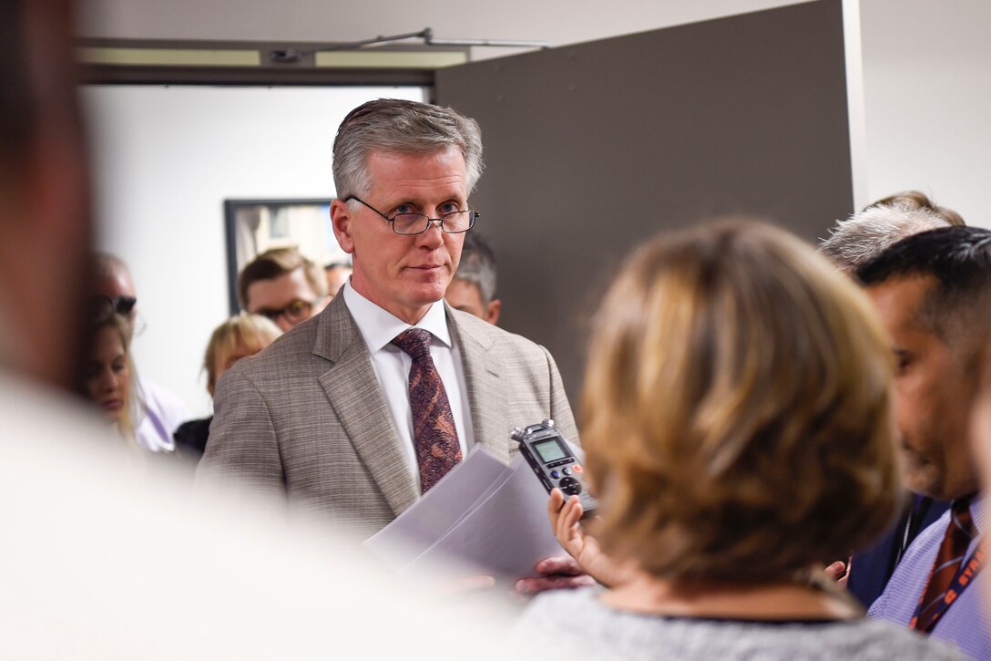 A man speaks to reporters.