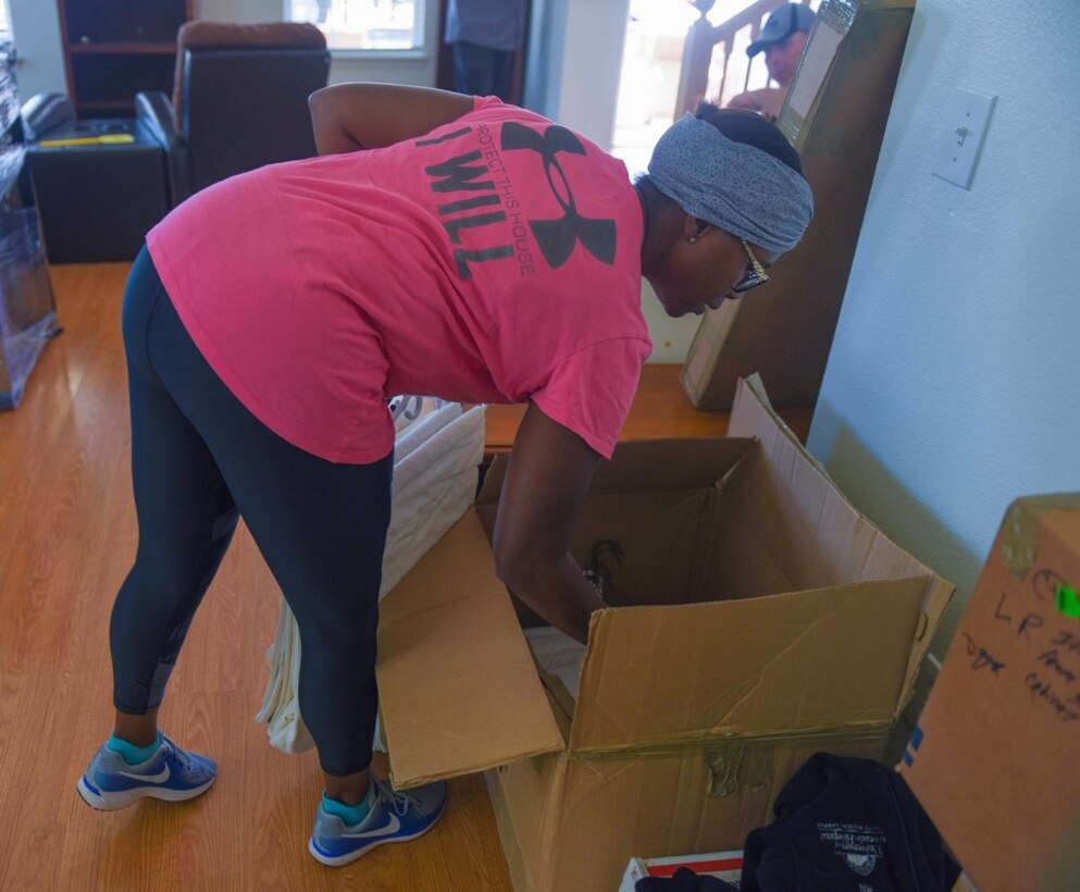 A woman unpacks a box.