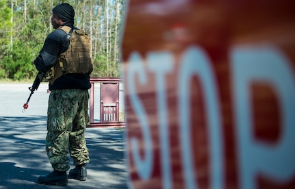 Engineman Petty Officer 1st Class Brian Thomas, Coastal Riverine Squadron 10 Bravo 2nd Platoon, stands guard during a deployment exercise March 6, 2019, at Joint Base Charleston, S.C. -- Naval Weapons Station.