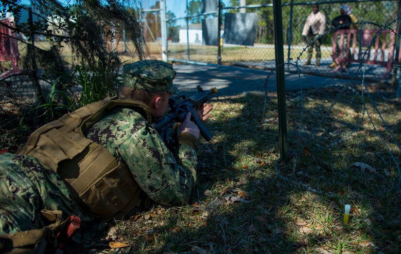 Master-at-Arms Petty Officer 3rd Class Adam Bolas, Coastal Riverine Squadron 10 Bravo 2nd Platoon, assumes a firing position during one of the simulations for a deployment exercise March 6, 2019, at Joint Base Charleston, S.C. -- Naval Weapons Station.
