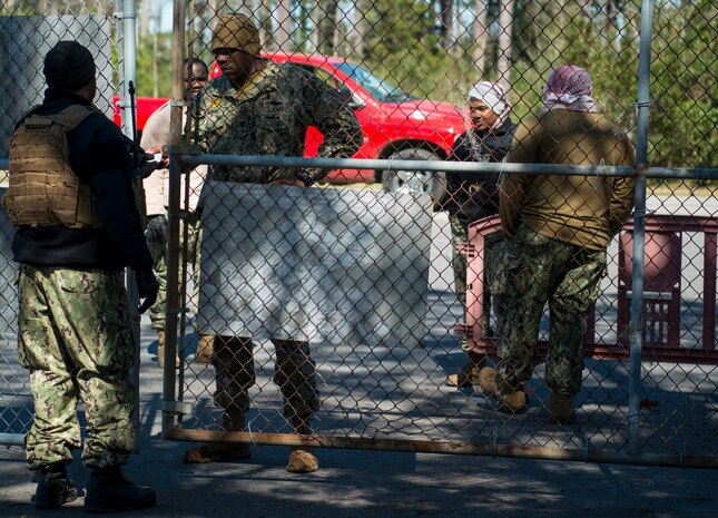 Engineman Petty Officer 1st Class Brian Thomas, Coastal Riverine Squadron 10 Bravo 2nd Platoon, checks identification cards during a deployment exercise March 6, 2019, at Joint Base Charleston, S.C. -- Naval Weapons Station.