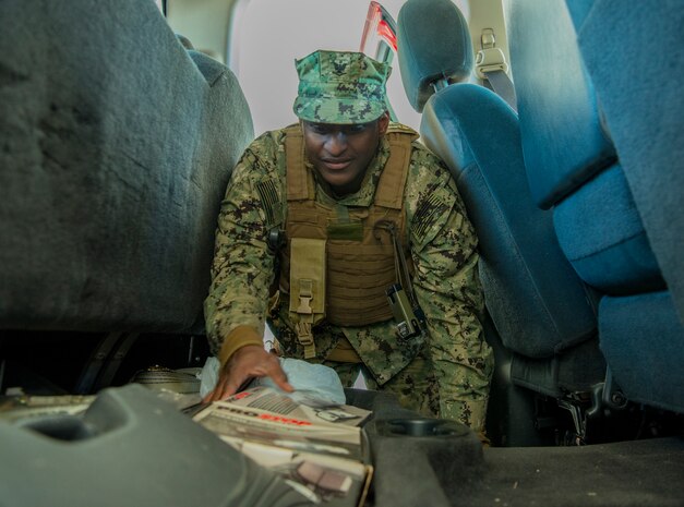 Master-at-Arms Petty Officer 3rd Class Larry Pool, Coastal Riverine Squadron 10 Bravo 2nd Platoon, performs a vehicle inspection during one of the simulations for a deployment exercise March 6, 2019, at Joint Base Charleston, S.C. -- Naval Weapons Station.
