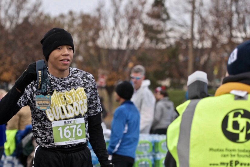 A cadet poses after completing a half marathon.