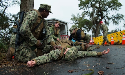 Sailors from the Coastal Riverine Squadron 10 Bravo 2nd Platoon perform first aid procedures on a simulated casuality during a deployment exercise March 5, 2019, at Joint Base Charleston, S.C. -- Naval Weapons Station.