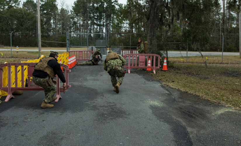 Saliors from the Coastal Riverine Squadron 10 Bravo 2nd Platoon, take cover during one of the simulations for a deployment exercise March 5, 2019, at Joint Base Charleston, S.C. -- Naval Weapons Station.