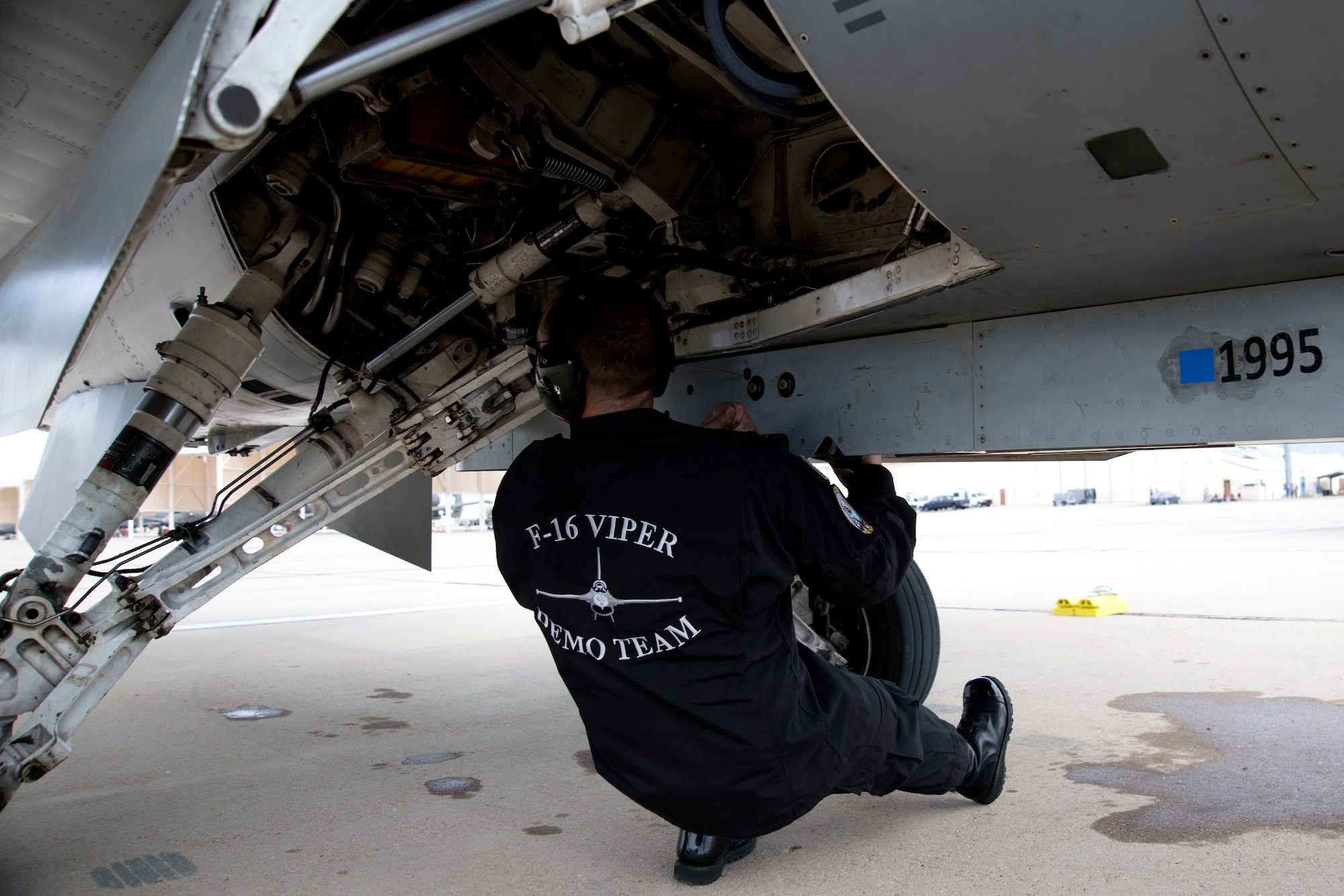 U.S. Air Force Staff Sgt. Ryan Davis, F-16 Viper Demonstration Team aircraft engines craftsman, performs preflight checks on an F-16 Fighting Falcon on the flight line at Davis-Monthan Air Force Base, Ariz., March 2, 2019.