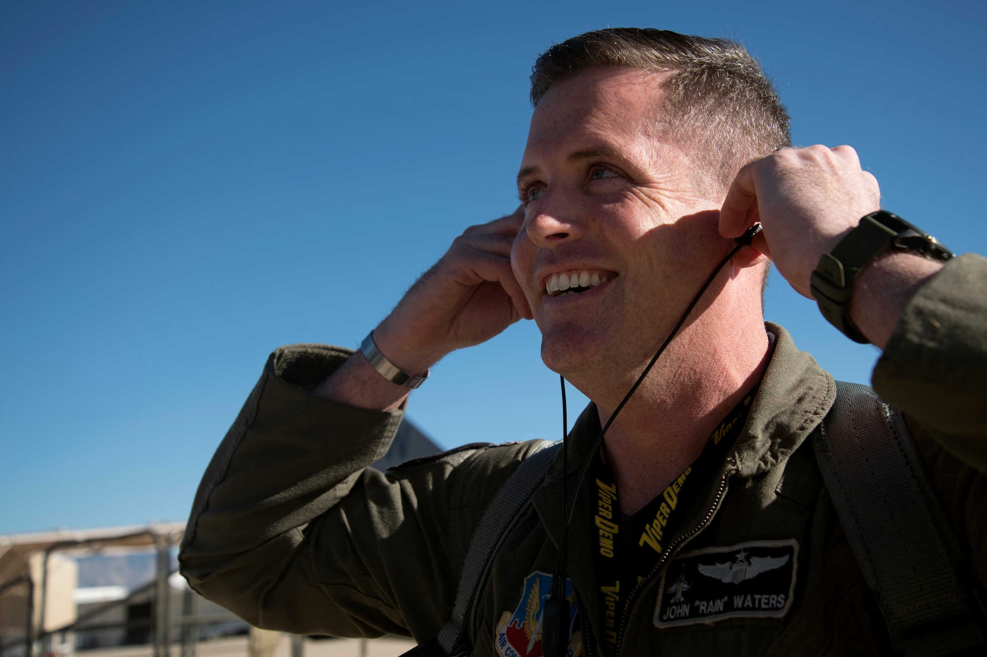 U.S. Air Force Maj. John Waters, F-16 Viper Demonstration Team pilot and commander, prepares his ear protection on the flight line at Davis-Monthan Air Force Base, Ariz., Feb. 28, 2019.