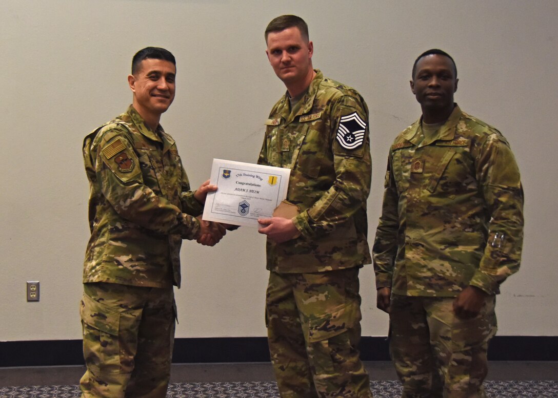 U.S. Air Force Col. Ricky Mills, 17th Training Wing commander, presents Master Sgt. Adam Heim, 17th Contracting Squadron superintendent, a certificate of promotion to the rank of senior master sergeant during the senior master sergeant release ceremony at the Event Center on Goodfellow Air Force Base, Texas, March 7, 2019. Within the Air Force, only 10 percent of enlisted members will make it to the rank of senior master sergeant. (U.S. Air Force photo by Airman 1st Class Zachary Chapman/Released)