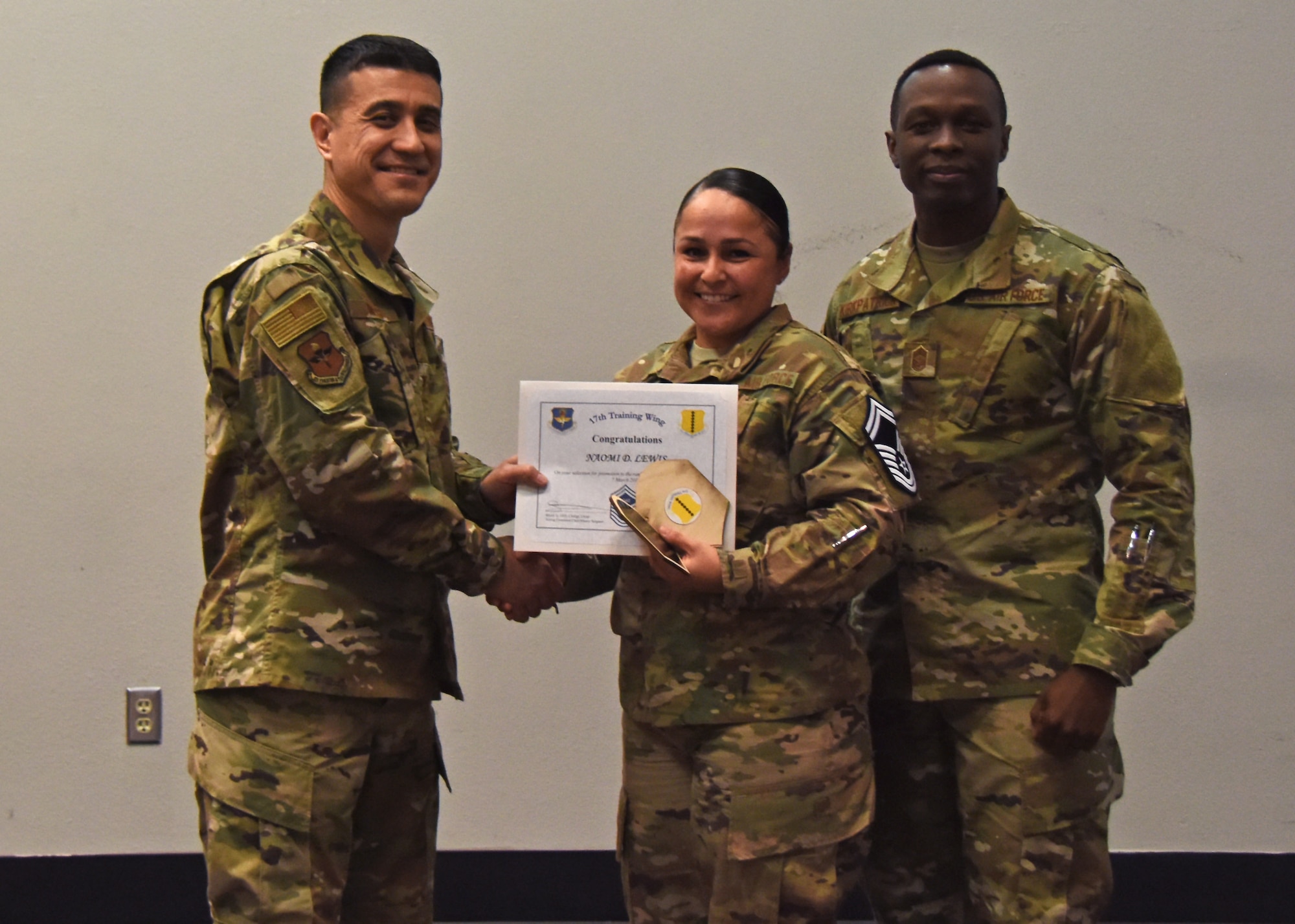 U.S. Air Force Col. Ricky Mills, 17th Training Wing commander, presents Master Sgt. Naomi Lewis, 17th Force Support Squadron superintendent, a certificate of promotion to the rank of senior master sergeant during the senior master sergeant release ceremony at the Event Center on Goodfellow Air Force Base, Texas, March 7, 2019. With the promotion more is expected of the selectees’, as senior enlisted leaders, they must reflect the highest qualities of a leader and professional. (U.S. Air Force photo by Airman 1st Class Zachary Chapman/Released)