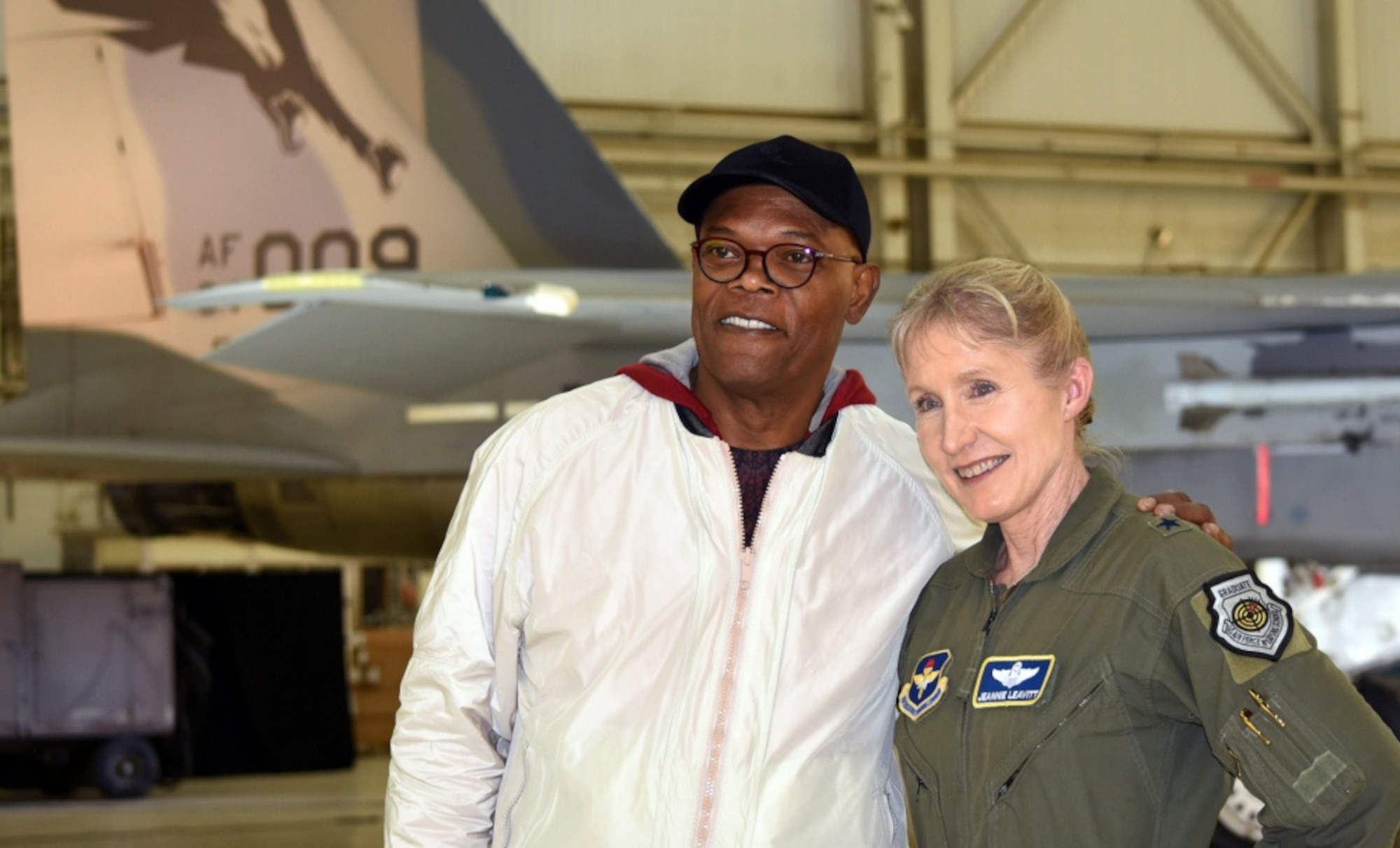 Actor Samuel L. Jackson poses with Gen. Jeannie Leavitt after receiving a challenge coin from her during a media event for "Captain Marvel" at Edwards Air Force Base, Calif., Feb. 20, 2019. Leavitt, the first Air Force female fighter pilot, was a consultant on the movie, and Jackson reprised his Nick Fury role. (DoD photo by Shannon Collins)