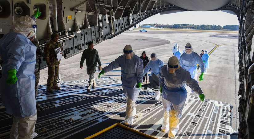 Airmen transport simulated patients onto a C-17 Globemaster III during a transportation isolation system training exercise March 6, 2019, at Joint Base Charleston, S.C. Engineered and implemented after the Ebola virus outbreak in 2014, the TIS is an enclosure the Department of Defense can use to safely transport patients with highly contagious diseases.