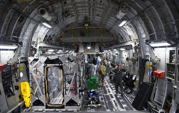A U.S. Air Force C-17 Globemaster III is prepped to transport a transportation isolation system March 6, 2019, during a training exercise that allows Airmen to practice the most effective and safest form of transportation for patients and their medical professionals. Engineered and implemented after the Ebola virus outbreak in 2014, the TIS is an enclosure the Department of Defense can use to safely transport patients with highly contagious diseases.