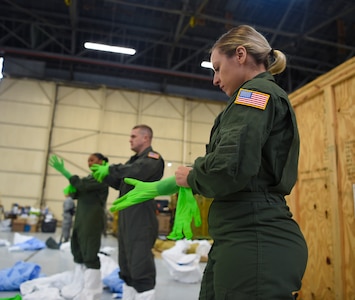 U.S. Air Force Staff Sgt. Laura Mendoza dons her personal protection equipment March 5, 2019, during transportation isolation system training at Joint Base Charleston, S.C. Mendoza is a respiratory therapist from the 60th Surgical Operations Squadron at Travis Air Force Base, Calif. Engineered and implemented after the Ebola virus outbreak in 2014, the TIS is an enclosure the Department of Defense can use to safely transport patients with highly contagious diseases.