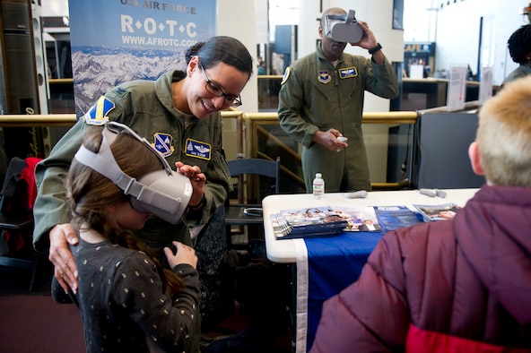 U.S. Air Force Col. Xavi Slocum, the Individual Mobilization Augmentee to the Air Force District of Washington commander, helps her daughter with a virtual reality headset during the release of Captain Marvel and Air Force STEM fair at the Smithsonian National Air and Space Museum in Washington D.C., March 7, 2019. (U.S. Air Force photo by Master Sgt. Michael B. Keller)