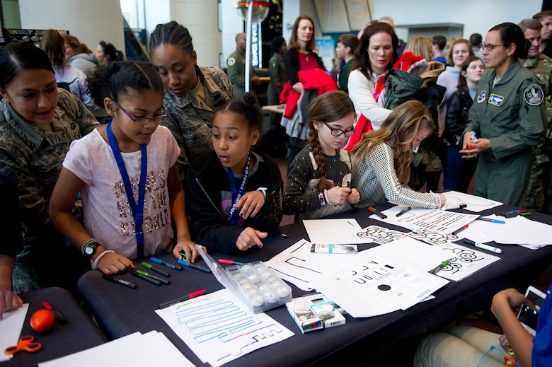 Air Force District of Washington and Air Combat Command Airmen and their daughters create paths for small robots during the Air Force STEM fair at the Smithsonian National Air and Space Museum in Washington D.C., March 7, 2019. (U.S. Air Force photo by Master Sgt. Michael B. Keller)