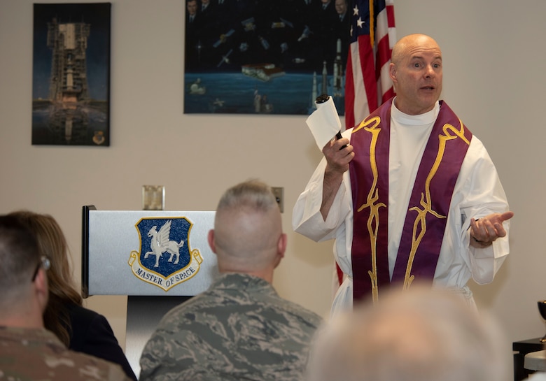 Maj. Mark McGregor, 50th Space Wing Individual Mobilization Augmentee chaplain, addresses participants during an Ash Wednesday service at the event center, Schriever Air Force Base, Colorado, March 6, 2019. McGregor joined the 50th SW Chapel Office and is expanding on-base support to include Catholic services. (U.S. Air Force photo by Staff Sgt. Matthew Coleman-Foster)