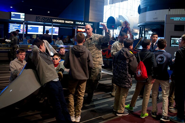 U.S. Air Force Tech. Sgt. Christopher Whitney, a 317th Recruiting Squadron Recruiter, center, speaks with students during the release of Captain Marvel and Air Force STEM fair at the Smithsonian National Air and Space Museum in Washington D.C., March 7, 2019. (U.S. Air Force photo by Master Sgt. Michael B. Keller)