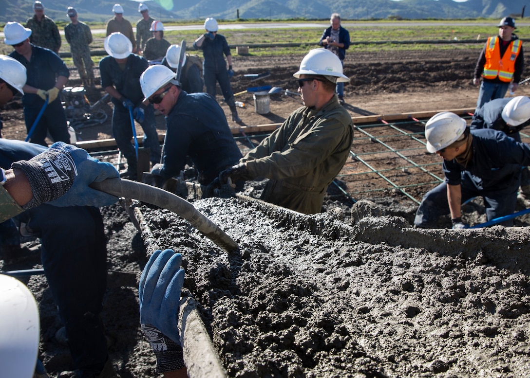 Marines with Marine Wing Support Squadron (MWSS) 373, Marine Wing Support Group (MWSG) 37, 3rd Marine Aircraft Wing (MAW), pour concrete during the Catalina Island Conservancy "Airport in the Sky" project at Catalina Island, Calif., Jan. 24. 3rd MAW's partnership with the Catalina Island Conservancy is a unique opportunity for Marines to conduct applicable training while also helping the community.   (U.S. Marine Corps photo by Lance Cpl. Juan Anaya)