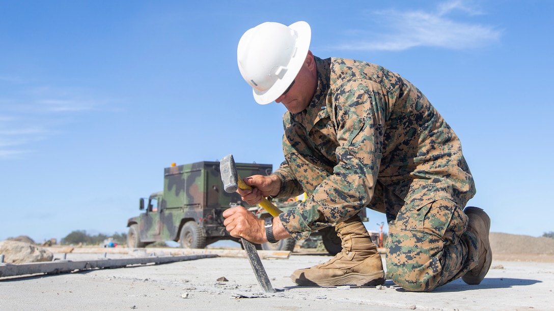 1st Lt. Andrew E. Wallace, an engineer officer with Marine Wing Support Squadron (MWSS) 373, Marine Wing Support Group (MWSG) 37, 3rd Marine Aircraft Wing (MAW), chisels concrete during the “Catalina Island Airport in the Sky” project at Catalina Island, Calif., Feb. 25. 3rd MAW's partnership with the Catalina Island Conservancy is a unique opportunity for Marines to conduct applicable training while also helping the community. (U.S. Marine Corps photo by Lance Cpl. Juan Anaya)