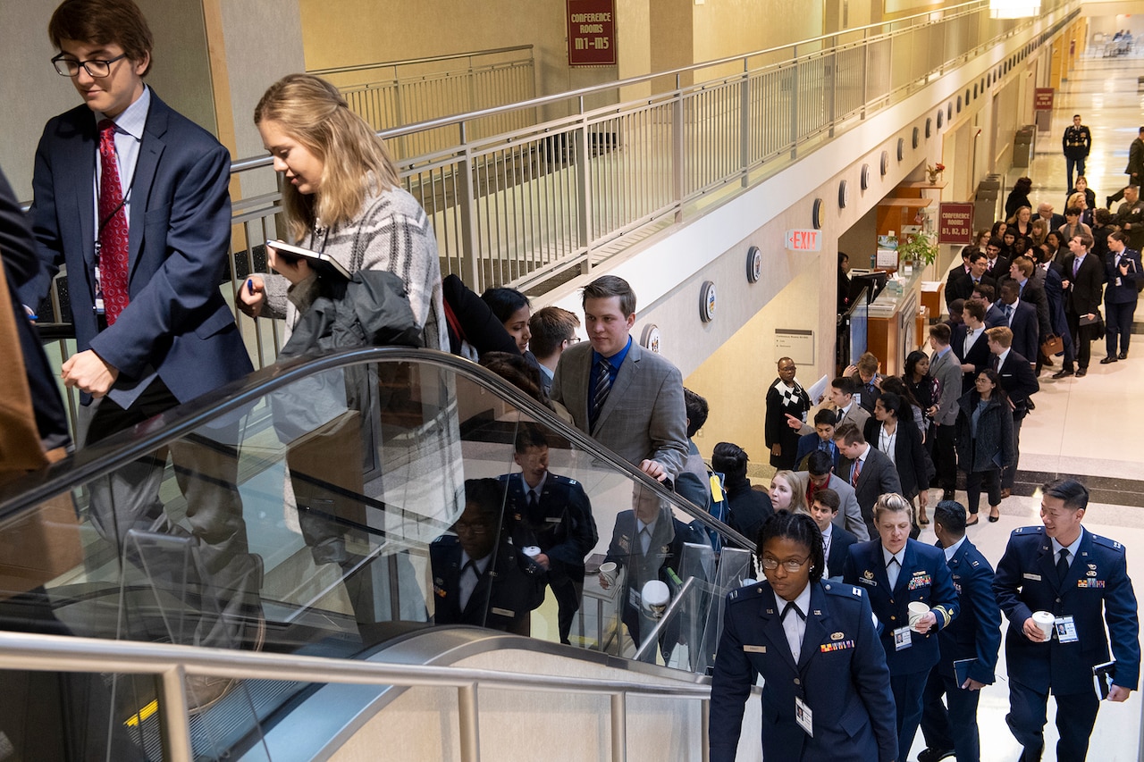 People ascend an escalator.