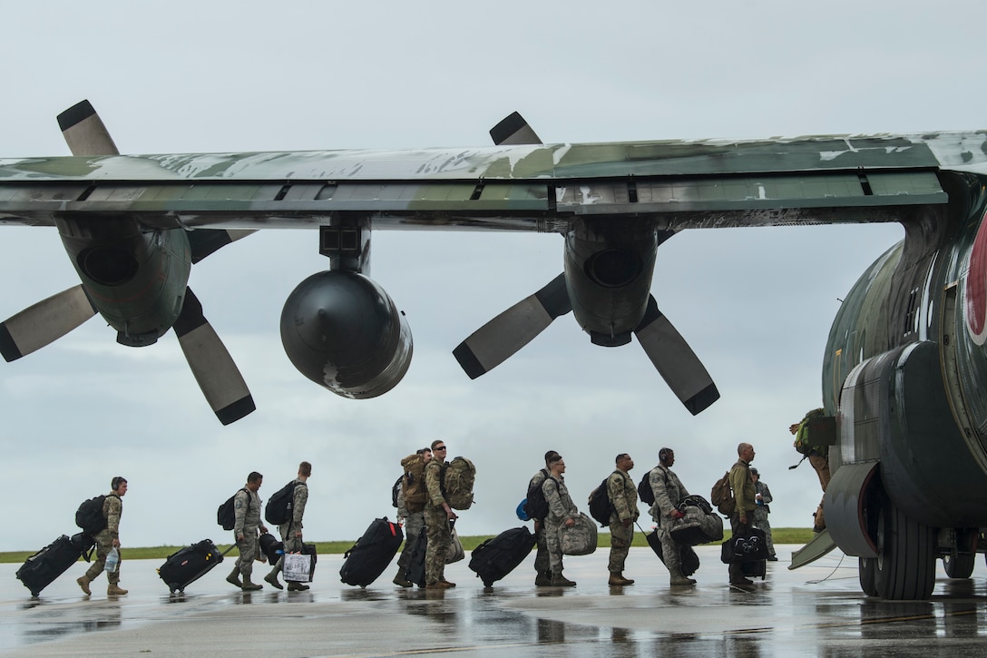 Line of troops load into cargo plane