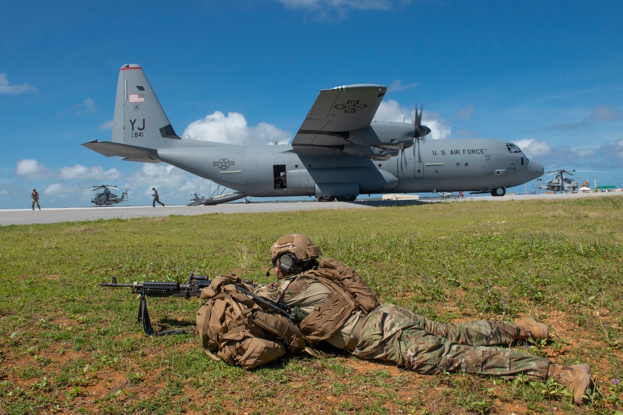 Airman with weapon and a C-130