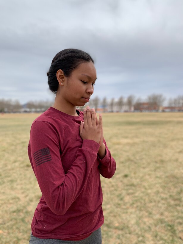 Staff Sgt. Chelsey Barnes, 377th Medical Group, takes part in the Yoga session at Hardin Field March 8. The session was conducted as part of Women's History Month here at Kirtland. (Air Force photo by Jessie Perkins)