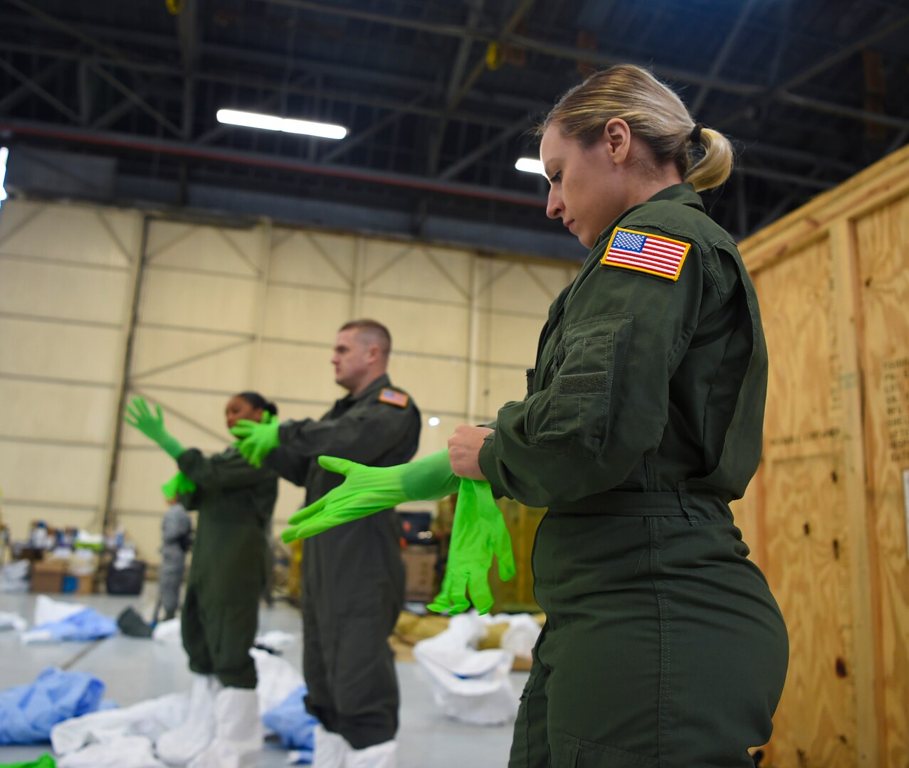 Image of Staff Sgt. Laura Mendoza as she dons her personal protection equipment during transportation isolation system training at Joint Base Charleston, South Carolina, March 5, 2019.