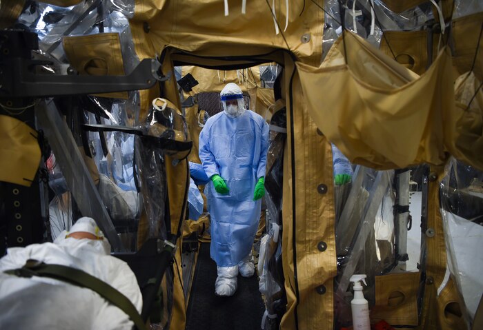 An Airman performs the final set of checks during transportation isolation system training March 5, 2019, while practicing patient care in a containment unit at Joint Base Charleston, S.C. Engineered and implemented after the Ebola virus outbreak in 2014, the TIS is an enclosure the Department of Defense can use to safely transport patients with highly contagious diseases.