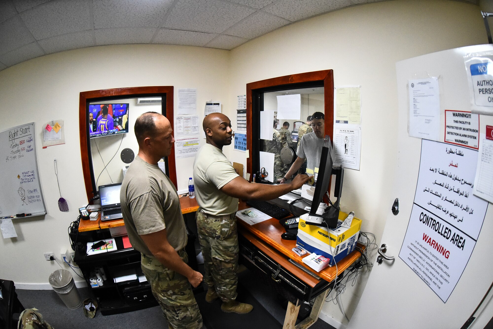 Maj. Christopher Wilkes, 380th Air Expeditionary Wing comptroller, and Staff Sgt. Ellis Robinson, 380th AEW customer service technician and cashier, assist a customer at Al Dhafra Air Base, United Arab Emirates, Mar. 7, 2019. From determining the availability of funds to processing the dispersal of payments to performing audits, the 380th AEW financial management team keeps a watchful eye on ADAB’s financial data to ensure that funds are being utilized responsibly and efficiently. (U.S. Air Force photo by Senior Airman Mya M. Crosby)