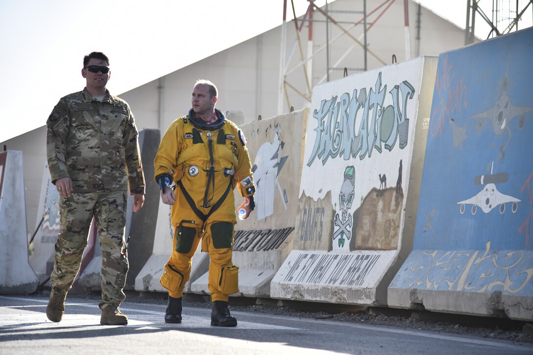 Maj. Thomas Skinner, 99th Expeditionary Reconnaissance Squadron flight doctor and Maj. John Blase, 99th ERS U-2 Dragon Lady pilot, walk after Blase’s flight at Al Dhafra Air Base, United Arab Emirates, Mar. 5, 2019. The U-2 pilots must wear a full pressure suit to be able to fly at 70,000 feet in the air. (U.S. Air Force photo by Senior Airman Mya M. Crosby)
